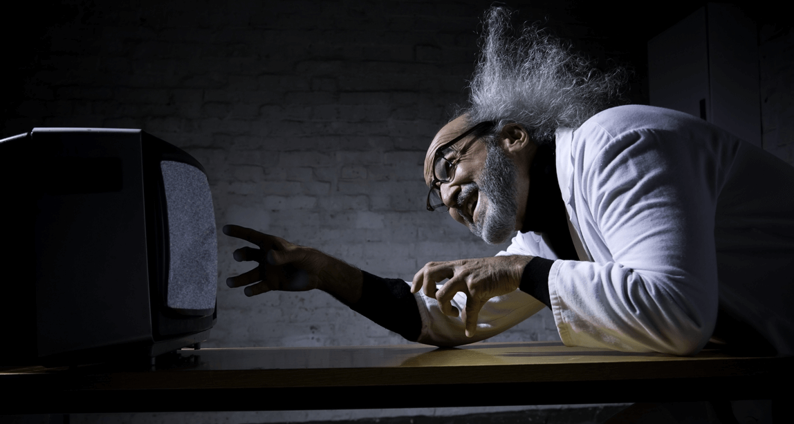 Mad-Scientist-with-hands-in-front-of-a-blurry-tv